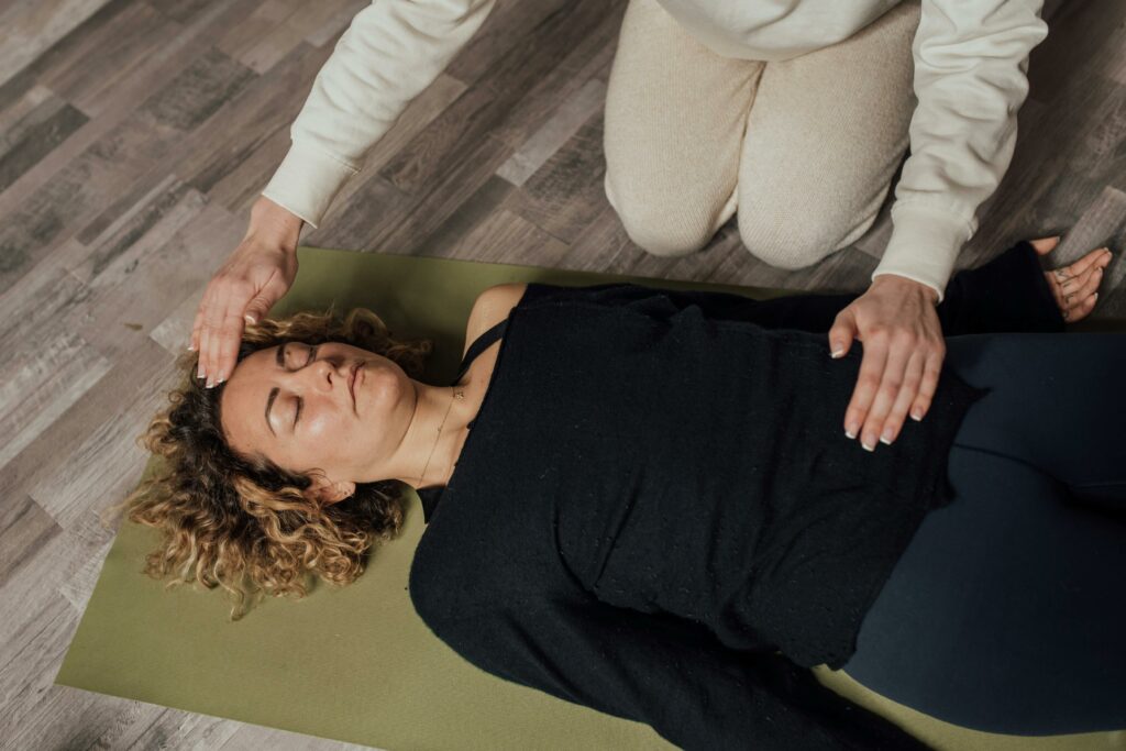 A woman practices holistic healing with eyes closed, focusing on relaxation and wellness.