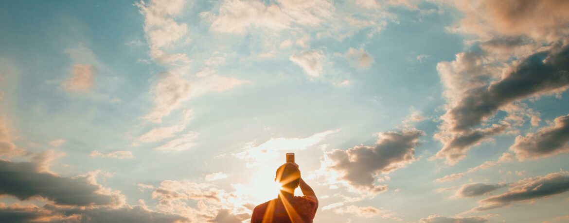 Silhouette of a figure meditating against a stunning sunset sky, creating a serene and peaceful atmosphere.