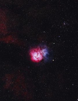 Stunning capture of the Trifid Nebula revealing its vibrant colors and expansive star field.